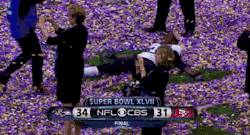 dailydot:  Baltimore Raven making a confetti angel after winning