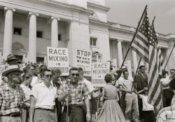 UNITED STATES - CIRCA 1959: people holding signs and American