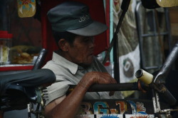 A Becak driver takes a break while waiting for customer. Bandung,