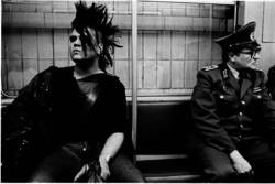 East German punk taking the U-Bahn next to an Volkspolizei officer,