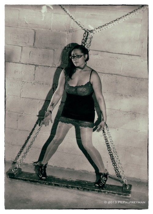 syoja:  pepalfreyman:  Lilly Elizabeth, trapped in a web of steel, unable to escape the groping hands of her evil captor…  Don’t let the caption fool you ;) He is exciting to be held captive by.  He has the best restraints and devices out of any