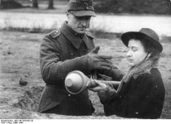 error888:  A German woman being shown how to use a Panzerfaust,