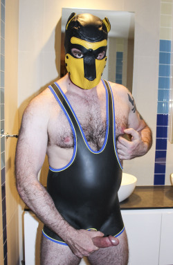 Pup is looking awesome in his leather pup hood and neoprene wrestler