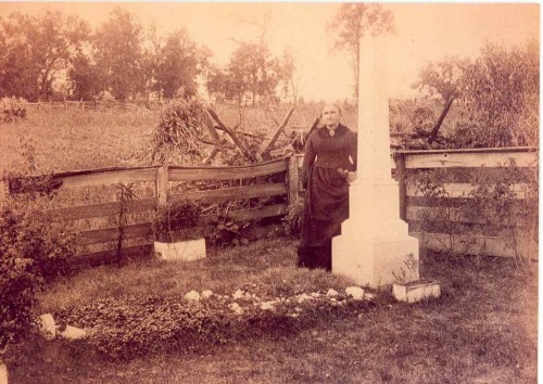 Zerelda James stands at the original grave of her son Jesse James