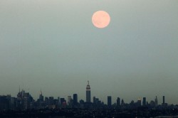  A full moon rises over the skyline of New York as seen from