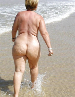 fat-naked-old-grannies:  Beach granny with flabby ass walks the