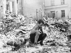  A young Polish boy returns to what was his home and squats among