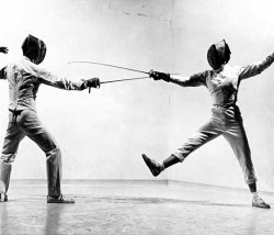 modernfencing:[ID: two foil fencers posing as if in a bout. The