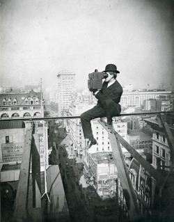Charles C. Ebbets takes a photo from atop a skyscraper in New