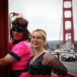 Cuffed to Golden Gate Bridge during rush hour in a neon pink