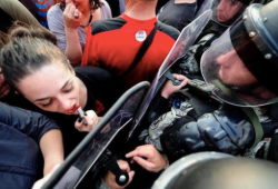 sixpenceee:  A woman protestor in Macedonia uses a riot shield