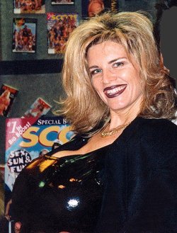 A lousy scan of a smiling n shining Busty Dusty in a latex top.