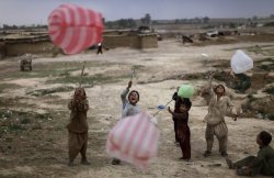 letswakeupworld:  Children play with plastic bags in a slum area