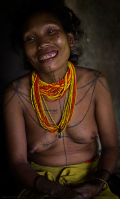 A Mentawai woman displaying traditional tattoo and sharpened