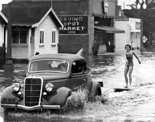 vintageeveryday:  Mary Anne Hawkins surfing the flooded streets