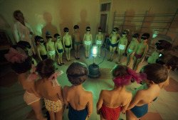 sixpenceee: School children circle around an ultraviolet lamp