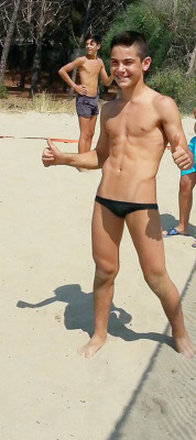 slip2015:  Sexy boy plays beach volley in hot black skimpy speedo