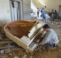 fnhfal:  A man plays piano in one of the palaces of ousted Iraq