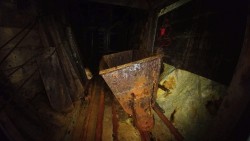 abandonedandurbex:  An ore cart and elevator lie abandoned far