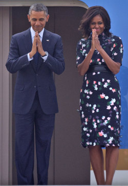 accras:  The president and first lady Michelle Obama fold their