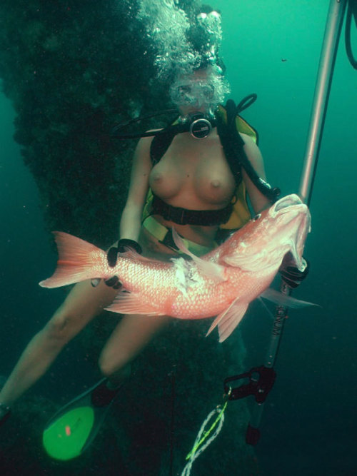 Nude underwater spear fishing.