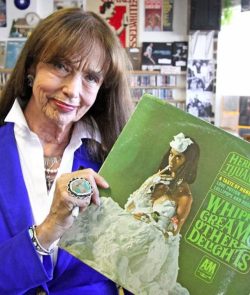 spinninwheel:  Dolores Erickson, now 76, holding a copy of the