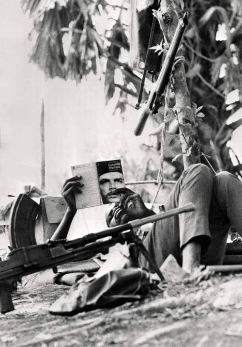 South Sudanese rebel rests and reads Guevara book about guerilla