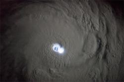 spaceexp:  Lightning in the center of a cyclone, taken from ISS