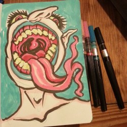 Ink on paper. Drawing random creatures with an open mouth  is