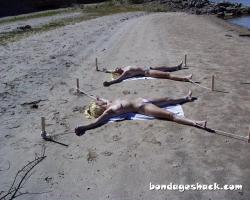 sirrendre:  two young women staked out topless on the beach 