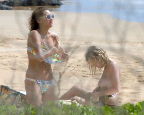 toplessbeachcelebs:Ashley BensonÂ sunbathing topless in Hawaii (July 2014)