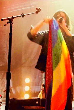 hozieredits:Hozier with a pride flag during Take Me To Church