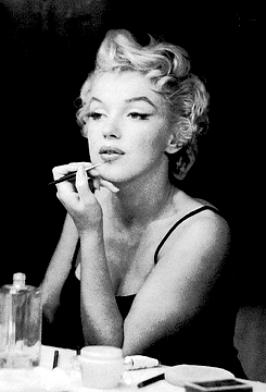 adoringlana:  Marilyn Monroe does her makeup photographed by