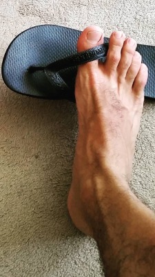 thongfaggot:  The foot of a real man playing with his well worn,