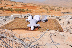 islamic-art-and-quotes:  Praying on mosque ruins bulldozed by