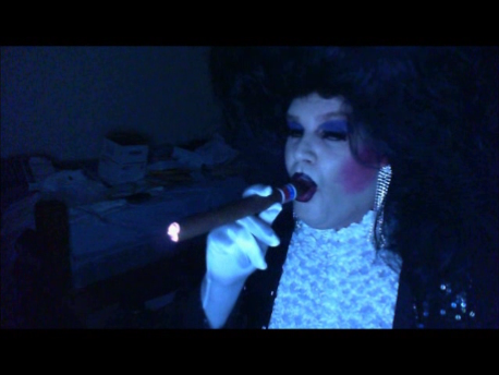 sissymarlenaexposed:  Sissy Faggot Tom Doran wearing a large black bouffant wig, black sequin jacket, white satin opera gloves, white popcorn blouse, rhinestone earrings, heavy makeup and smoking a giant cigar. 