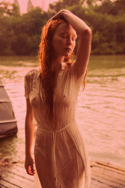 Lovely redhead all wet in see-through clothing.