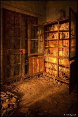 Books decaying on shelves in an abandoned castle in Spain. Love