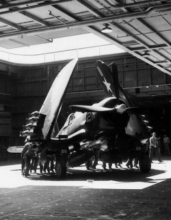 peerintothepast:  U.S. Navy Personnel maneuver an F4U Corsair