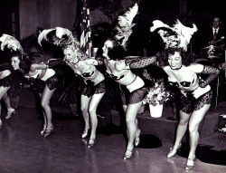 Vintage candid 50’s-era photograph of showgirls on stage, at an unidentified nightclub in Los Angeles..