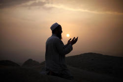 5835km:  A Muslim pilgrim prays atop Mount Thor in the holy city
