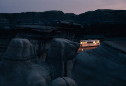 natgeofound:  A mobile home shines amid eerie rock formations