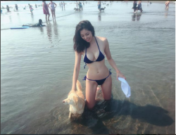   With her dog in the water .  