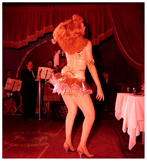Lynne O’Neill shakes her tail feathers.. Photographed during a 50’s-era performance at ‘Georgia’s Blue Room’; located on 129 West 48th Street, in New York City..