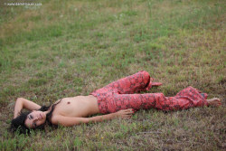 skinny hippie Yana relaxing topless in the grass. Photo Daniel
