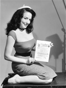 elevenacres:  Evelyn West poses with the policy she took out