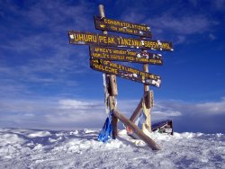 High above the Serengeti Plains (Uhuru Peak is the highest summit on Kibo’s crater rim; Kibo is the highest of Mt. Kilimanjaro’s three volcanic cones)