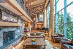 stylish-homes:  Living area with a glass wall and cedar-log posts