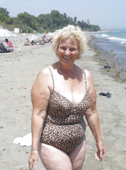 This sexy old beach granny is showing off her body for all the