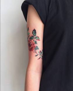 tattoofilter:  Red peony tattoo on the right upper arm. Tattoo